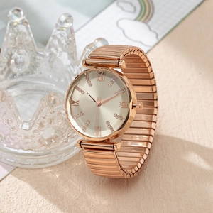 Detail of rose gold quartz watch with elastic band and Roman numeral rhinestone dial
