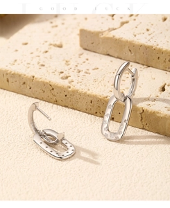 Macro shot of S925 sterling silver earring hallmark and linked geometric chains with cubic zirconia