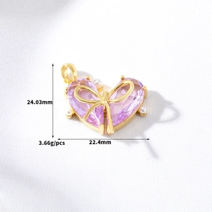 Detailed view of a purple heart pendant with bow and pearls, measuring 24.03x22.4mm