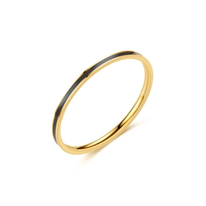Detail of minimalist gold titanium steel ring with black enamel center band inlay