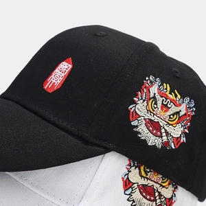 Detail of vibrant lion dance embroidery on cotton twill baseball cap fabric