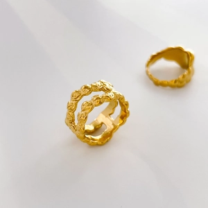 Detailed view of 18K gold plated titanium steel rings with unique hammered texture surface