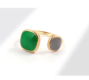 Detail of adjustable gold-plated ring featuring green and purple enamel square stones