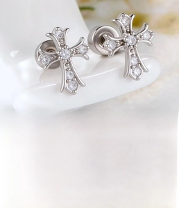 Macro view of silver cross stud earrings with cubic zirconia and round screw back closure