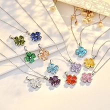 Detailed grid of clover-shaped heart necklaces with colorful crystals in various shades