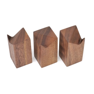 Close-up of geometric black walnut ring holders showing natural wood grain textures