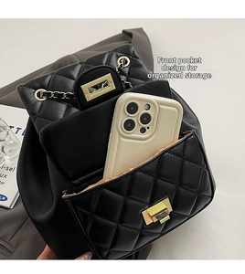 Detail of quilted black leather backpack showing front pocket storage for a smartphone