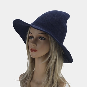 Detailed close-up of dark blue knitted witch hat with a pointed top and wide brim