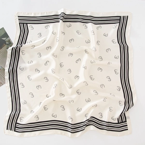 Detail of silk-like square scarf with black horseshoe print and elegant border