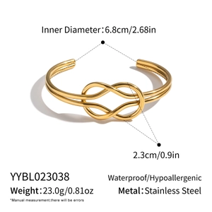 Macro detail of geometric knot design on 18K gold plated stainless steel bangle