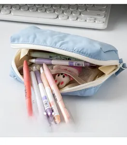 Close-up of light blue pencil case with internal mesh dividers and stationery storage