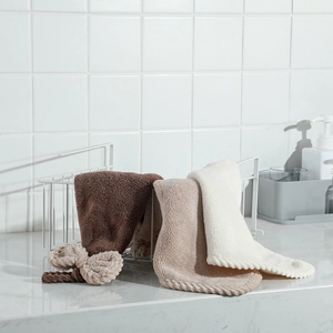 Detailed texture of soft coral fleece towels in brown and white within a bathroom basket