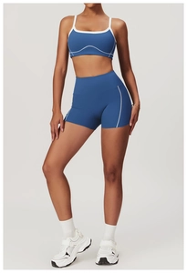 Detailed view of high-waist navy yoga shorts with white trim and elastic performance fabric