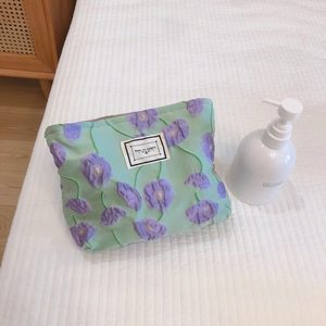 Floral relief makeup bag in light green canvas with purple flower embroidery detail