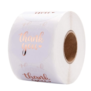 Roll of white round thank you stickers with rose gold foil lettering and heart icon
