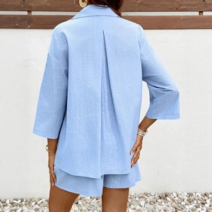 Detail of light blue maternity set featuring inverted back pleat and linen texture fabric