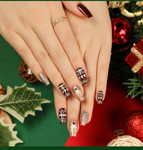 Detail of Christmas ballerina press-on nails featuring reindeer and snowflake art