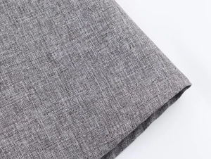 Macro detail of high-quality grey herringbone fabric showing texture and weave