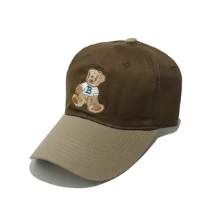Detail shot of 3D teddy bear embroidery on brown and khaki canvas baseball cap