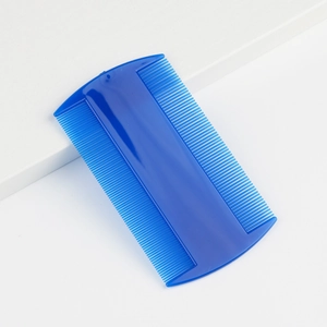 Close-up of dual-sided blue pet flea comb with fine and dense plastic teeth for grooming