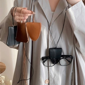 Detailed view of artificial leather glasses holder necklace in black and brown colors