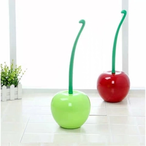 Detail of red and green cherry-shaped toilet brush sets on a tiled floor