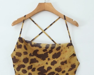 Detailed view of leopard print camisole featuring criss-cross thin shoulder straps