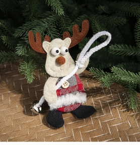 Close-up of a reindeer ornament with red plaid fabric and a bell on pine branches