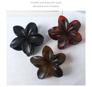 Three-piece matte flower hair claw clips in black, amber brown, and coffee resin