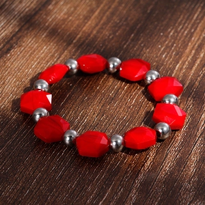 Detail of red faceted crystals and silver steel beads on Bohemian style bracelet