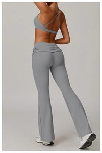 Detail of high-waist flared yoga pants with fold-over ruched waistband in grey blue