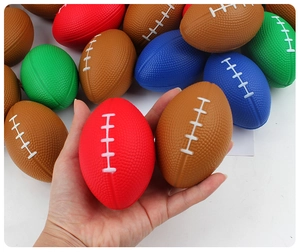 Close-up of colorful PU foam mini rugby stress balls in red and brown with white stitching
