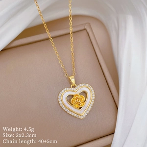 Macro detail of gold-plated heart necklace with rose flower and sparkling cubic zirconia