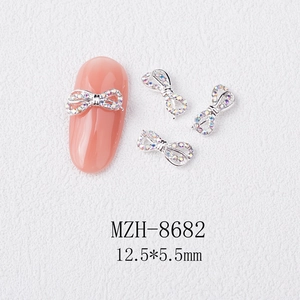 Macro shot of 12.5*5.5mm alloy bow nail charms with iridescent rhinestones and silver base