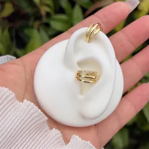 Three-layer 18K gold plated ear cuff with sparkling white cubic zirconia on a model ear