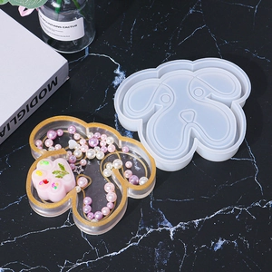 Detailed view of dog-shaped silicone mold with finished glitter resin jewelry tray