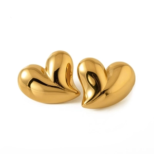 Polished 18K gold heart-shaped earrings with reflective metallic finish on white background