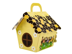 Detail view of yellow bee-themed house-shaped paper candy gift box with honeycomb roof