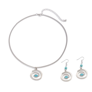 Detail of silver spiral necklace and hook earrings set with turquoise stone inlays