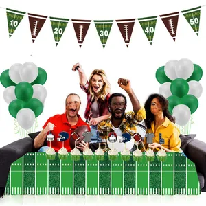 Detail of football party kit with stadium turf tablecloth, balloons and touchdown decor