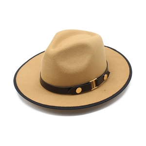 Close-up of camel wool fedora with black leather band and gold buckle detail
