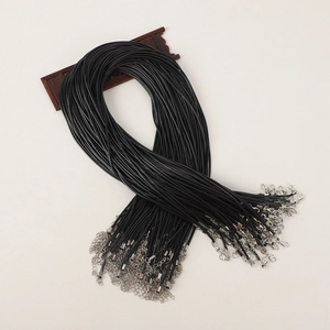 Macro view of black waxed cord necklace bulk with silver lobster clasps and extension chains