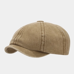 Makrodetail aus gewaschenem Baumwollstoff und präzisen Nähten an der Khaki-Schiebermütze