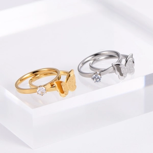 Macro detail of luxury butterfly rings with frosted wings and sparkling zircon stone