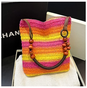 Detail of colorful rainbow straw beach bag with wooden beaded handles and striped pattern