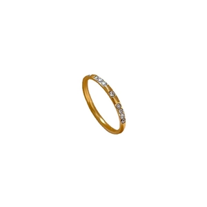 Minimalist gold titanium steel ring with sparkling micro-inlaid zircon crystals on white background