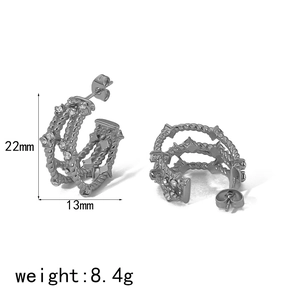 Detailed view of silver twisted C-shape earrings with inlaid diamonds and 22mm dimensions