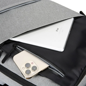 Gray business laptop backpack with USB port and organized storage compartments for devices