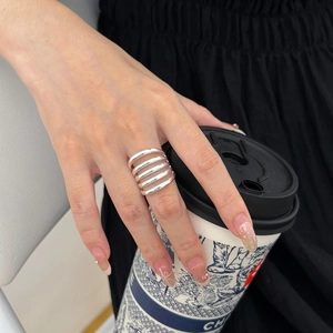 Macro detail of 5-layer geometric hollow wide band ring in 925 sterling silver