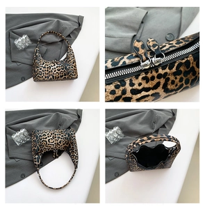 Detail view of leopard print bucket bag showing zippers, top and side angles on white desk